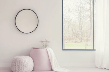 Minimalist interior design composition in neutral colors with a mirror next to a large window, a rug and a sofa.