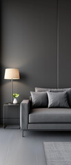 A living room with a grey couch and a lamp