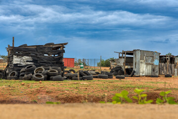 shanty town , shack made of used tiers and corrugated sheet galvanized metal, township informal settlement,