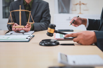 A lawyer meets with clients in a professional office, offering expert legal consultation and representation. Specializing in business planning, they operate within private firms or as freelance