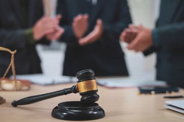 A lawyer meets with clients in a professional office, offering expert legal consultation and representation. Specializing in business planning, they operate within private firms or as freelance