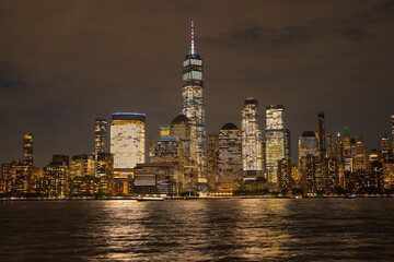 Obraz premium Night in The NYC city, USA, United States. Night day with iconic buildings. New York City NYC Manhattan Downtown Skyline, viewed from Jersey City, USA.