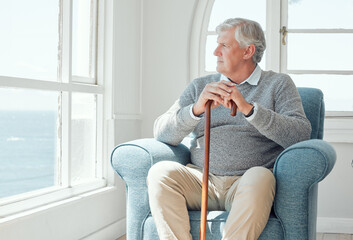 Senior man, thinking and window with cane for memory, Alzheimers or reflection on pass events at old age home. Elderly male person, pensioner or retirement with stick on chair in wonder for daydream