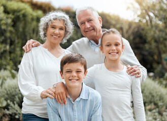 Fototapeta premium Grandparents, portrait and garden hug with children, outdoor love and bonding together in Scotland. Old people, countryside and embrace kids for security in relationship, weekend visit and holiday