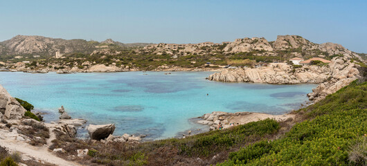 Punta Tegge beach on the island of La Maddalena in north-eastern Sardinia, surrounded by a mountainous landscape and turquoise waters with no people