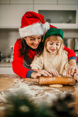 Family of two enjoying time together at home baking Xmas sweets