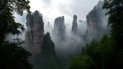 Zhangjiajie National Forest Park: The towering sandstone pillars of Zhangjiajie National Forest Park, shrouded in mist and greenery.
