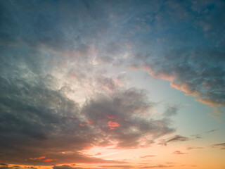 The rays of the sun breaking through the dramatic clouds in the evening or in the morning in the sunset or sunrise sky.