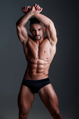 Fototapeta premium Topless man with muscle. Sexy male body. Handsome sexy model. Shirtless muscled male model. Man with a naked torso. Muscular young man with perfect body stripping. Sexy man. Seductive guy.