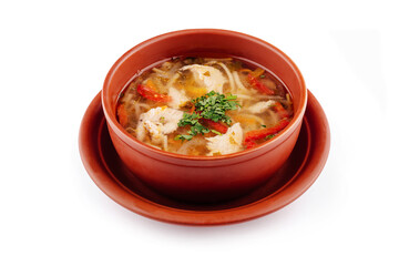 Steaming chicken noodle soup with vegetables in brown bowl