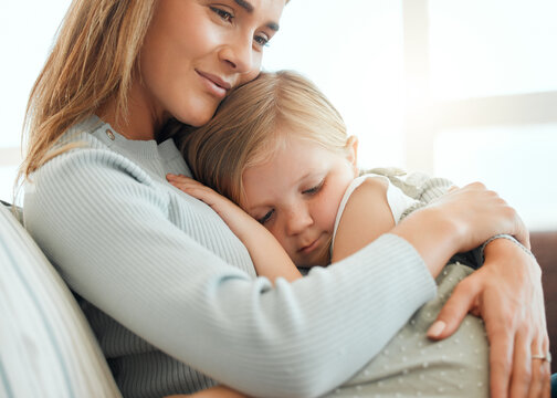 Mother, girl and hug for comfort in home, console child and support or care for sad kid on couch. Mama, daughter and embrace for security in relationship, family bonding and empathy or compassion