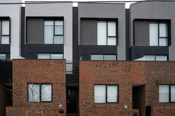 Exterior two-story residential townhouses with modern and contemporary styles. Concepts of property, real estate, detached houses, and the housing market.