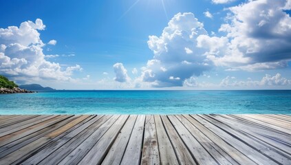 Obraz premium Wooden Deck Overlooking a Tranquil Blue Ocean and Sky with White Clouds