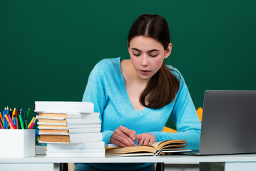 Student girl in classroom. School teenager girl in middle school. Schoolgirl in high school. College student learning in college classroom. Education concept. Lesson and homework in university.