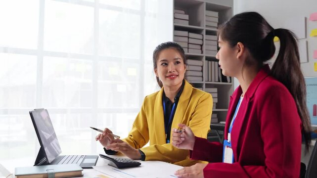 Business idea creative brainstorming sessions for projects Strategic topic of two Asian girls working together data analysis Happy clarification of various financial information at the desk.