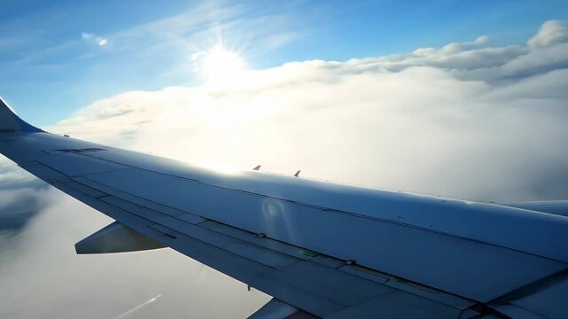 Airplane is adjusting its wing flaps while flying above the clouds