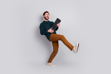 Photo of cheerful optimistic man wear stylish clothes have fun dance isolated on gray color...
