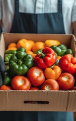 Closeup of a box of fresh colorful bell peppers and tomatoes.