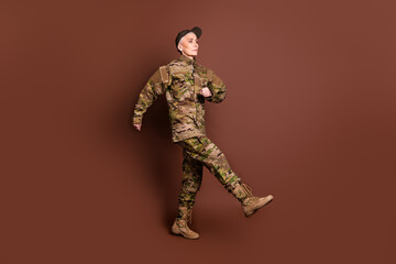 Full body photo of attractive mature woman army soldier walk marching wear military uniform...