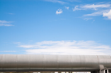 pipeline, blue sky and clouds in the background
