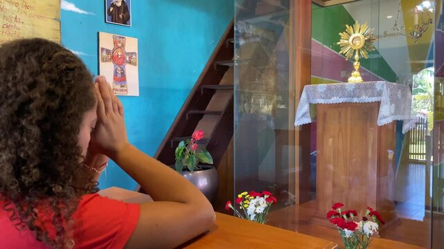 shot 2: Woman praying in a Catholic church