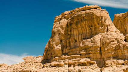 high rocky mountains in the desert against the blue sky and white clouds in Egypt Dahab South Sinai