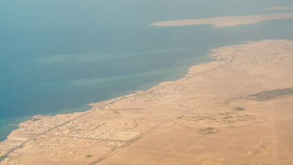 view from the plane window of the Red Sea and the desert in Egypt
