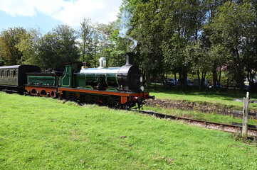 Fototapeta premium Victorian steam engine pulling a passenger train in the UK.