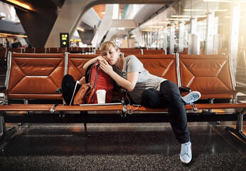 Woman, sleeping or waiting room with earphones at airport for flight delay, departure or jet lag....