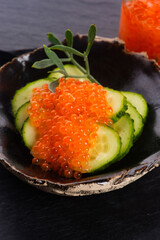 Appetizer. Cucumber with salmon trout caviar