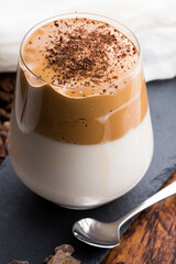 Dalgona coffee in glass cup. Korean trendy drink from instant coffee, milk and brown sugar