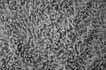 Processed image of fluffy gray doormat from bathroom in grey color