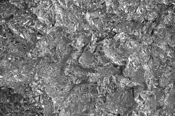 Processed collage of shiny metal silver gray foil crumpled packaging material texture