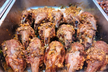 Rabbit meat is delicacy in Sichuan province in China. Featured here rabbit head grilled with sauces, for sale in food stall.