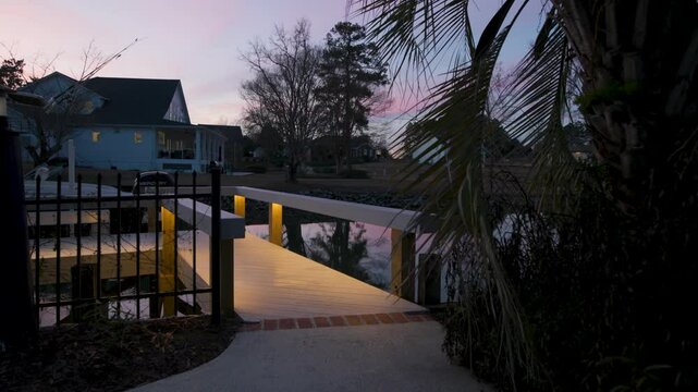 Slow motion walk on to a lit boat dock at a lake in the evening. Lake Murray in South Carolina.