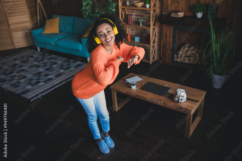 Wall mural Photo of shiny cute girl dressed orange pullover headphones staying home having fun indoors house apartment room