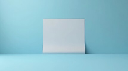 A white sheet of paper is on a blue wall