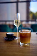 espresso coffee and sparkling wine, prosecco and bumble ice coffee with orange on the table