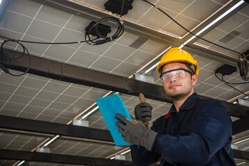 Engineer technical service checking solar panel while monitoring the system of solar panel on his tablet to make sure that's it work properly