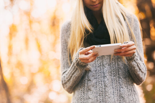Autumn: Using A Cell Phone During A Fall Walk