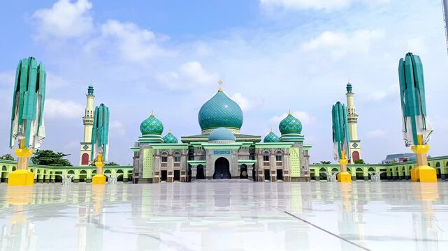 An-Nur Great Mosque, a grand mosque in Pekanbaru, Riau, Indonesia. Among the largest in the country, captured on 29th August under a blue, semi-cloudy sky, highlighting its architectural magnificence