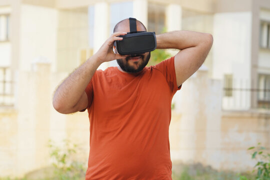 Bald indian Man Wearing VR Headset, Virtual Reality Headset - Powered by Adobe