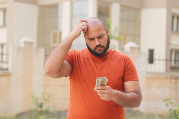 Confused Bald indian Man Looking at Money, Indian Rupees