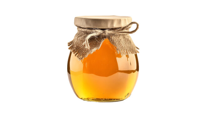 Organic honey in a glass jar, showcasing its rich, golden color, isolated on background.