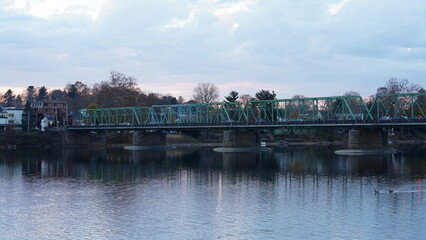 Fototapeta premium One old rion frames bridge view on the river with the sunset sky as background