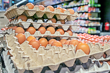 Chicken brown eggs in cardboard containers egg trays in a supermarket. Preparing for the Easter...