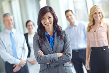 Fototapeta premium Woman, portrait and arms crossed in office, leadership and confidence in teamwork solidarity. Female person, collaboration and group for professional unity, support and manager in accounting firm