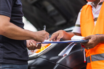 Man car problem crash breakdown signing claim contract insurance document with agent officer at roadside