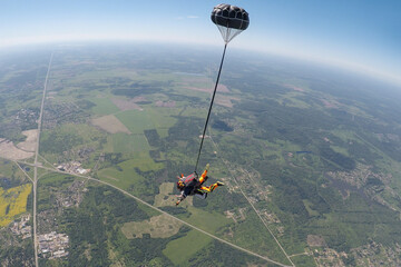 Skydiving tandem free falling with a small pilot chute