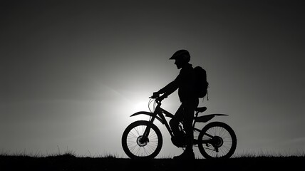 Obraz premium Monochrome Biker Against a Setting Sun